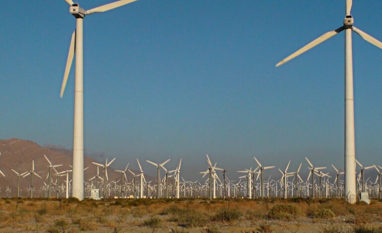 A bunch of windmills that are in the desert